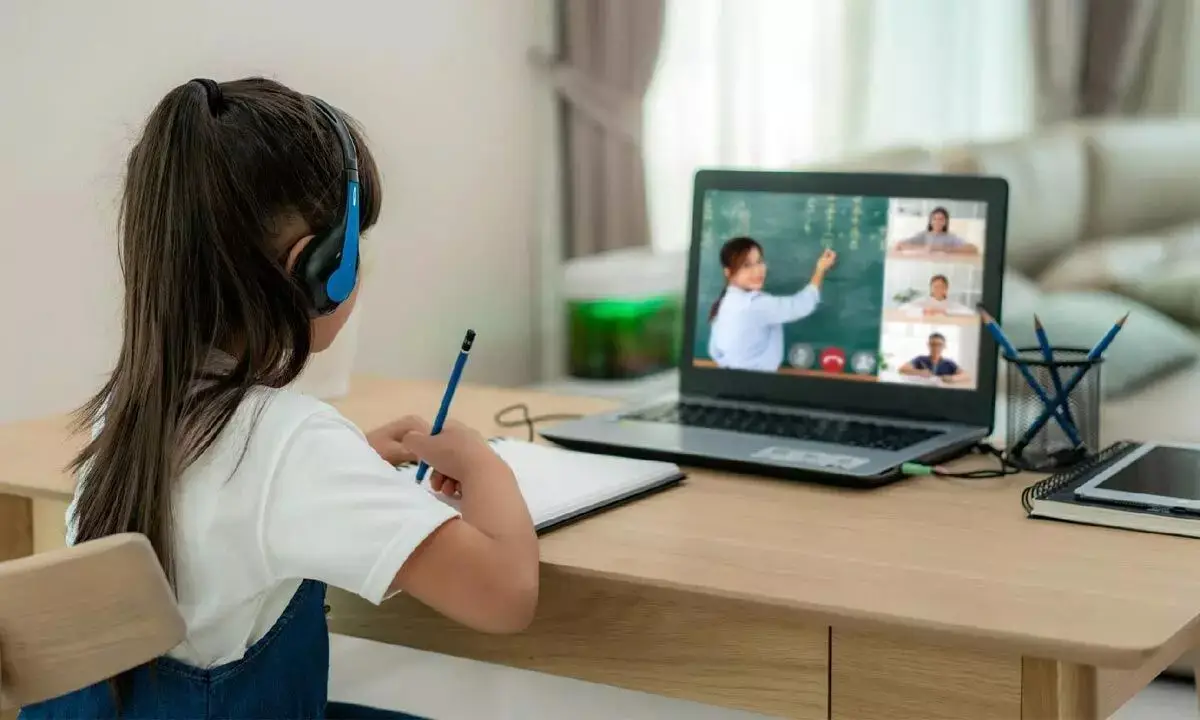 A Jain Public School student attending a virtual class from home